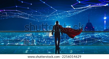 Hero Businessman standing at rooftop with Smart night city view. Business vision with smart big data technology concept