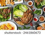 Hero shot spread of Thai cuisine with decorative garnish and side dishes