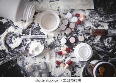 Heroin Powder, Pills And Syringe On The Dark Background.