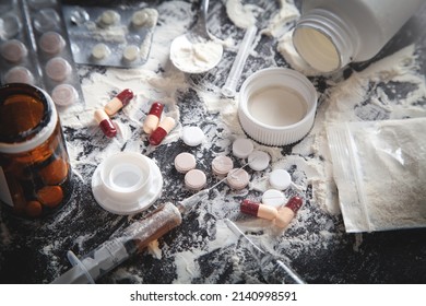 Heroin Powder, Pills And Syringe On The Dark Background.