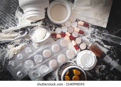 Heroin Powder, Pills And Syringe On The Dark Background.