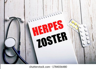 HERPES ZOSTER written in a white notebook near a stethoscope and pills on a light wooden table. Medical concept - Shutterstock ID 1784036480