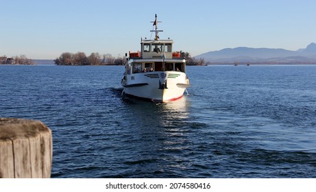 Herreninsel, Chiemsee, Germany - December 28, 2015: Local passenger ferry boat on Chiemsee lake, approaching landing pier