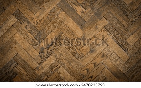 Herringbone wood tile pattern on a floor or wall with antique finish                     