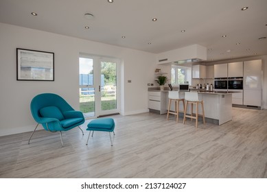 Hertfordshire, England - September 7 2018: Brand New Modern Fitted Kitchen Family Room Within Vacant New House On Recently Constructed Housing Estate With Breakfast Bar And Stools.