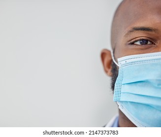 Hes Always Masked Up. Closeup Shot Of A Young Doctor Wearing A Mask At Work.