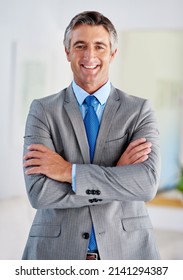 Hes the consummate corporate pro. Portrait of a smiling mature businessman standing with his arms crossed. - Shutterstock ID 2141294387