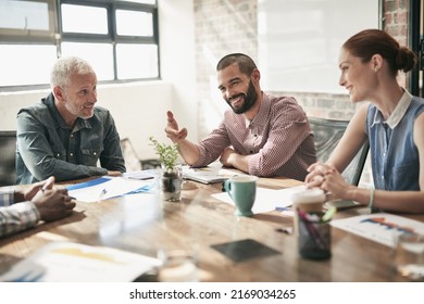 Hes A Good Team Player. Shot Of A Team Of Businesspeople Having A Meeting In An Office.