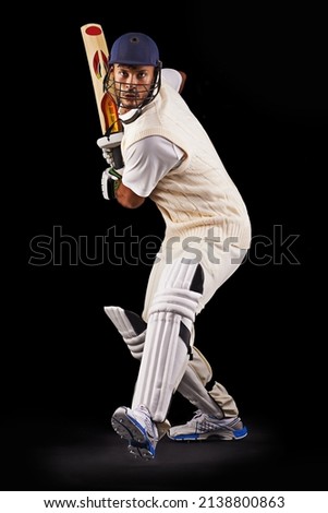 Hes got some talent with the bat. A cropped shot of an ethnic young man in cricket attire isolated on black.