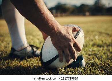 He's the kick master. Cropped shot of an unrecognizable rugby player preparing for a kick on the field during the day. - Powered by Shutterstock