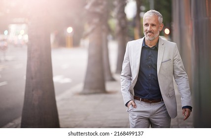 Hes A Real Go Getter. Shot Of A Mature Businessman Standing Outside.