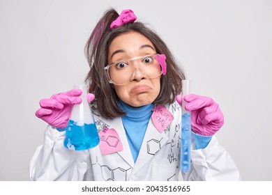 Hesitant Clueless Female Student Of Chemical Faculty Has Failed Experiment Looks Unhappily At Camera Poses With Glassware Dressed In Uniform. Researcher Invents Vaccines To Treat Covid 19 Virus