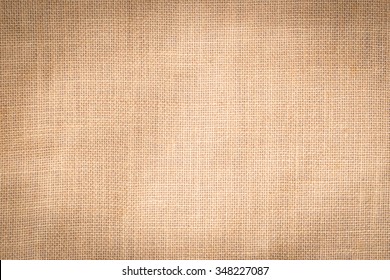Hessian sackcloth woven texture pattern background in light cream beige brown color 