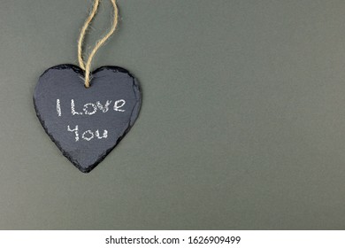 Hessian String Looped Through A Heart Shaped Slate Plaque With The Words  I Love You Written In White Chalk.