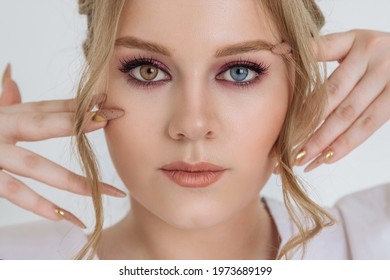 heterochromia in an attractive Caucasian young woman. face close-up, portrait of a beautiful woman with eyes of different colors of blue and brown. melanin, genetics