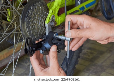 a hex key to repair a bicycle,installing a rear derailleur on a bicycle