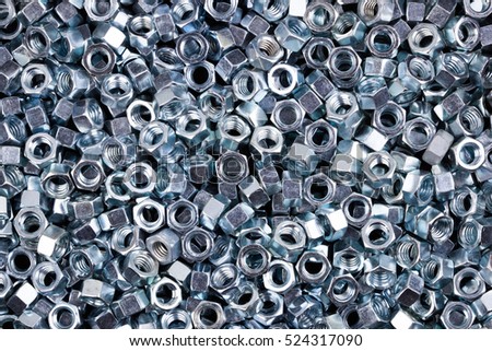 Hexagon metal nuts.  Textured background image.