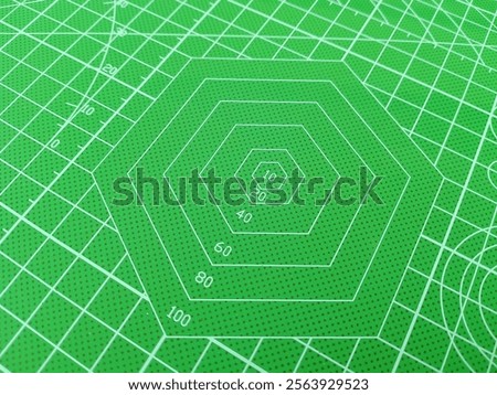 Hexagon pattern on cutting mat with green background 