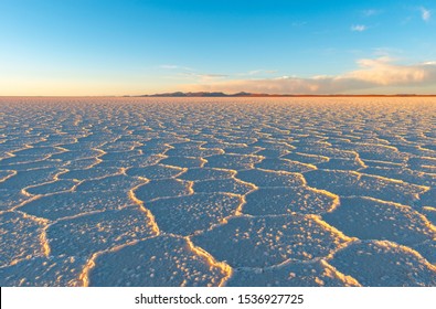 Hexagon salt formations at sunset in the Uyuni salt flat desert (Salar de Uyuni), Bolivia. - Powered by Shutterstock