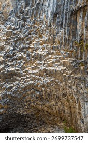the hexagonal basalt rock formations known as the Symphony of Stones in Garni Gorge, Armenia. These natural columns were shaped by volcanic lava cooling over time, creating a unique geometric pattern