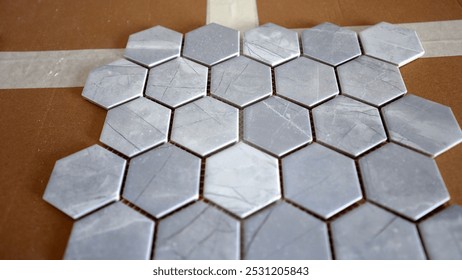 Hexagonal ceramic tiles with a honeycomb pattern, outlining intricate design details.