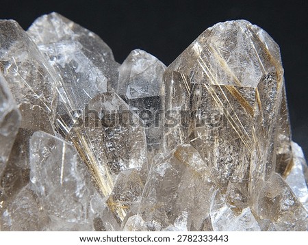 Hexagonal crystal points of rutilated quartz or Venus hair stone. Fine needles of metallic rutile run through the colourless quartz crystals