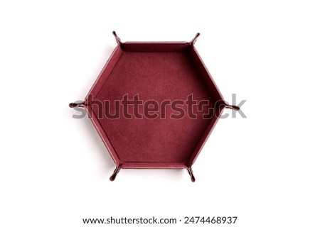Hexagonal leather dice tray with red interior, isolated on a white background. Gaming accessory, top view