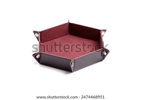 Hexagonal leather dice tray with red interior, isolated on a white background. Gaming accessory