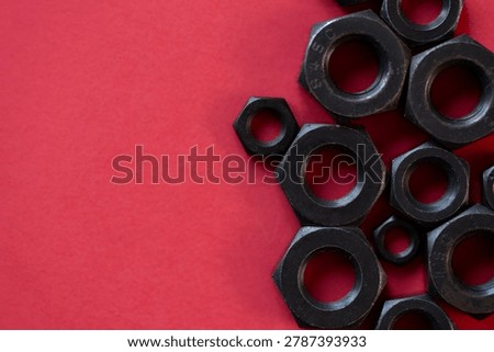 Hexagonal nuts on a red background