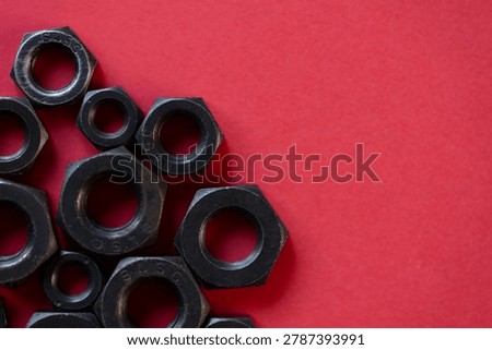 Hexagonal nuts on a red background