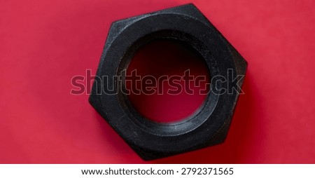 Hexagonal nuts on a red background