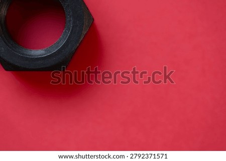 Hexagonal nuts on a red background