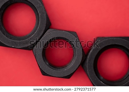 Hexagonal nuts on a red background