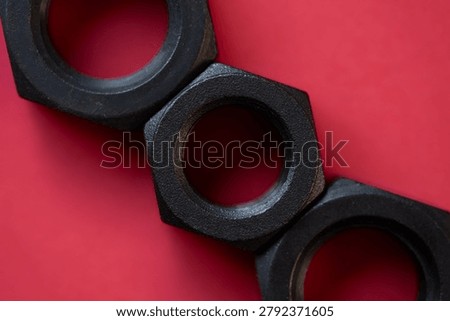 Hexagonal nuts on a red background