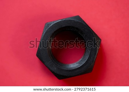 Hexagonal nuts on a red background