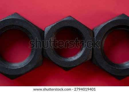 Hexagonal nuts on a red background