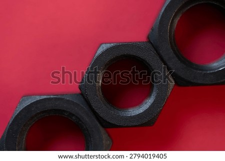 Hexagonal nuts on a red background