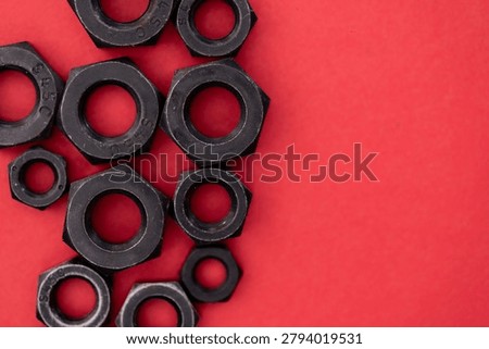 Hexagonal nuts on a red background