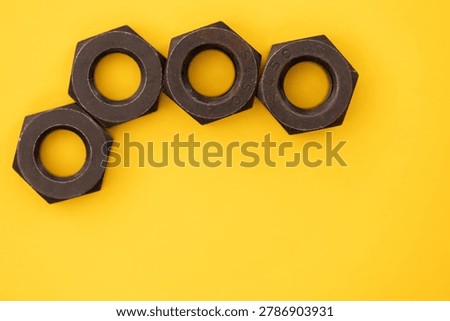 Hexagonal nuts on a yellow background