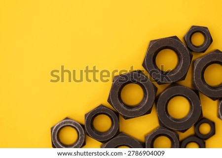 Hexagonal nuts on a yellow background