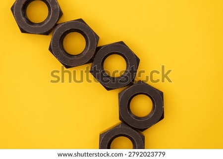 Hexagonal nuts on a yellow background