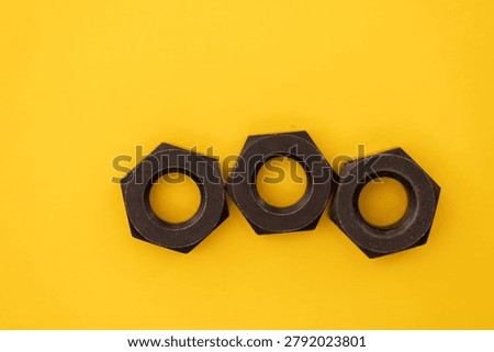 Hexagonal nuts on a yellow background