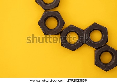Hexagonal nuts on a yellow background