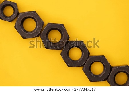 Hexagonal nuts on a yellow background