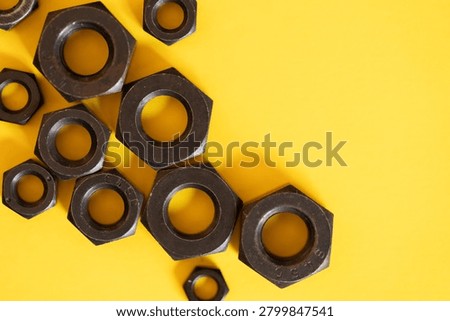 Hexagonal nuts on a yellow background