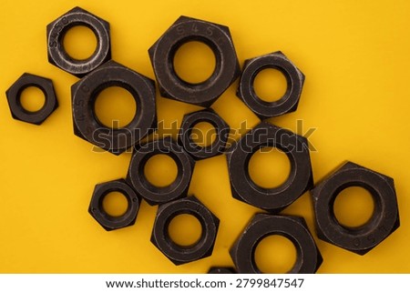Hexagonal nuts on a yellow background