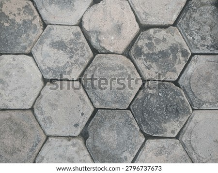 Hexagonal paving blocks in dull grey with a rough texture