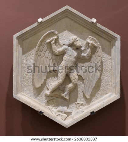 Hexagonal relief of Daedalus working with tools, symbolizing mechanical arts, by Andrea Pisano, Campanile di Giotto, Florence, Italy, 14th-century sculpture.