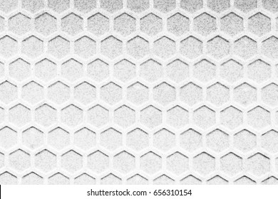 The hexagonal texture background in the black and white scene.