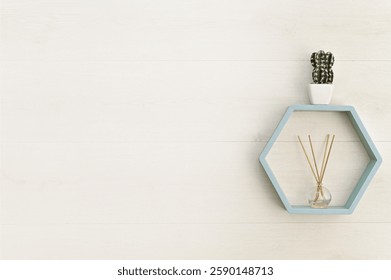 hexagonal wooden shelf on the wall with flower and aroma diffuser. empty space 